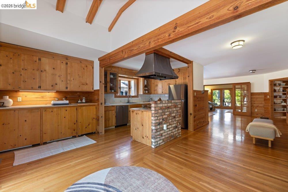287 Purdue Avenue Kensington, CA 94708 - Photo 29 of 60 Warm wood-finish flooring complements the exposed wood beams and paneling throughout this open-concept kitchen and living area