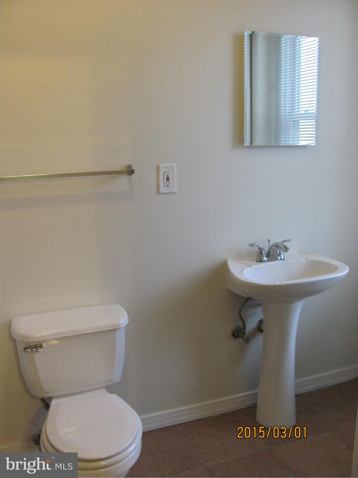 704 Quincy Street Northwest, Unit 202 Washington, DC 20011 - Photo 14 of 24 a bathroom with a sink a toilet and mirror