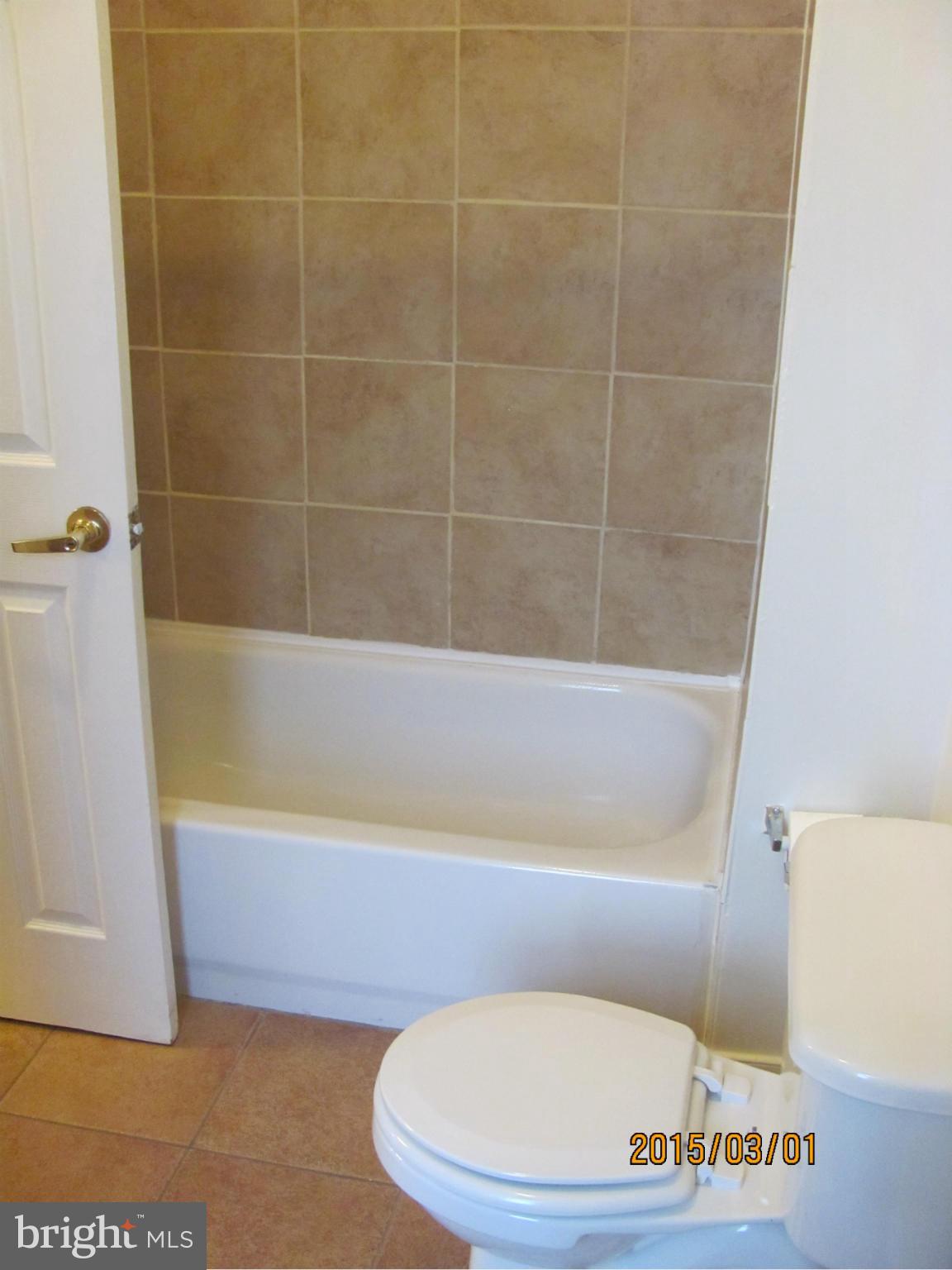 704 Quincy Street Northwest, Unit 202 Washington, DC 20011 - Photo 15 of 24 a bathroom with a tub and a toilet