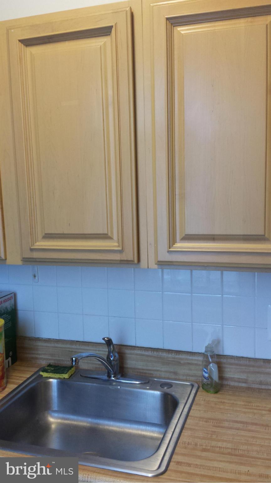 704 Quincy Street Northwest, Unit 202 Washington, DC 20011 - Photo 19 of 24 a kitchen with a sink and cabinets