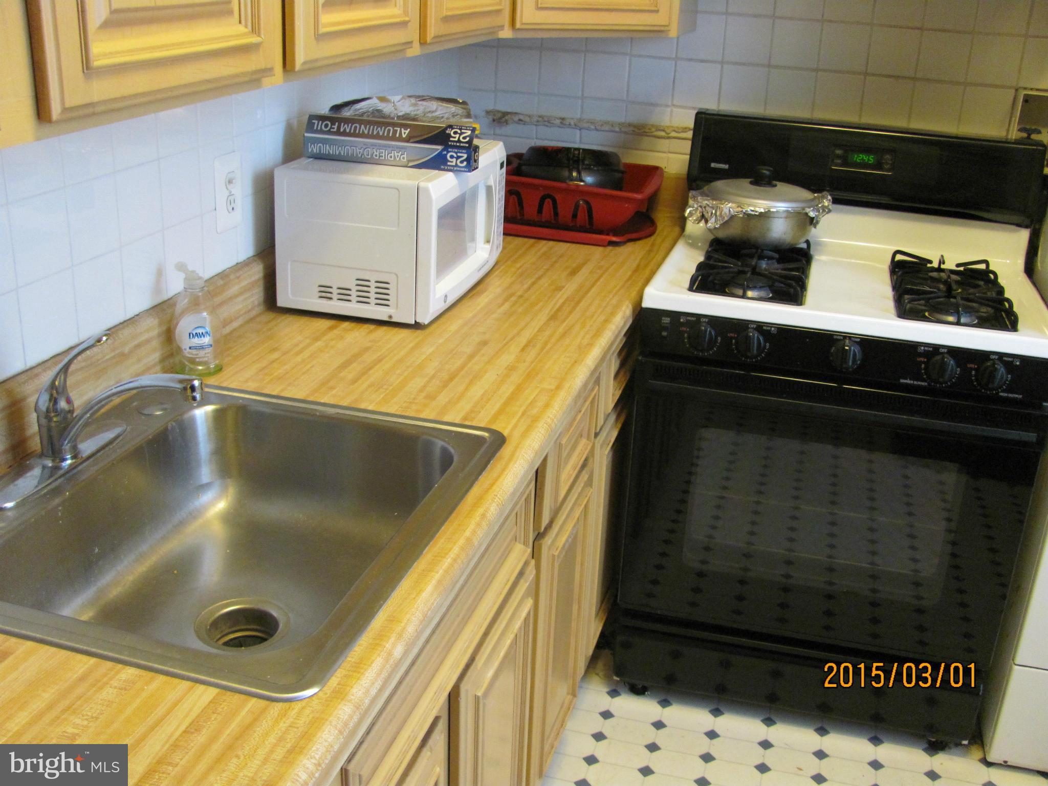 704 Quincy Street Northwest, Unit 202 Washington, DC 20011 - Photo 20 of 24 a bathroom with a sink and a washing machine
