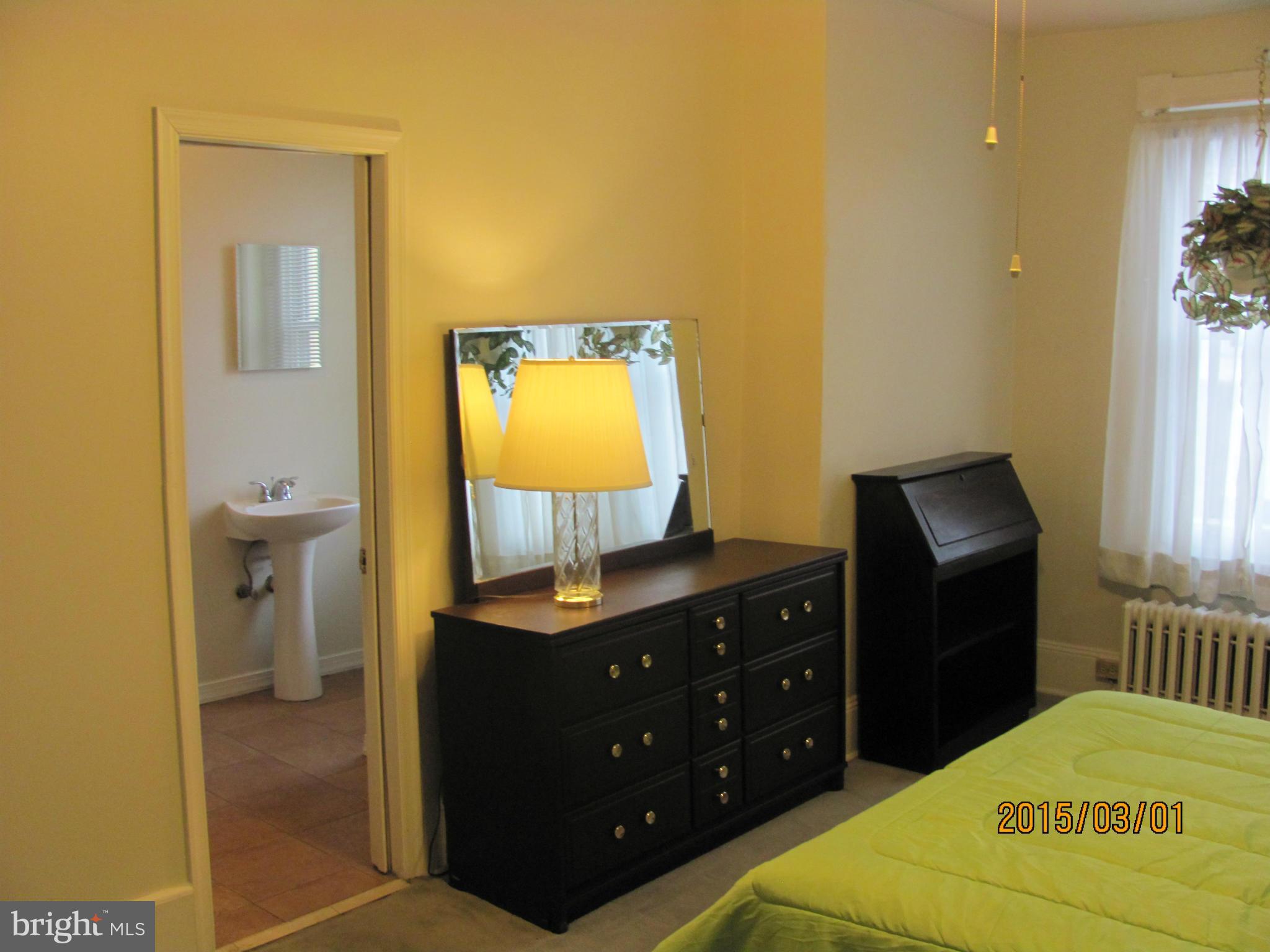 704 Quincy Street Northwest, Unit 202 Washington, DC 20011 - Photo 7 of 24 a bedroom with a bed and a dresser in it