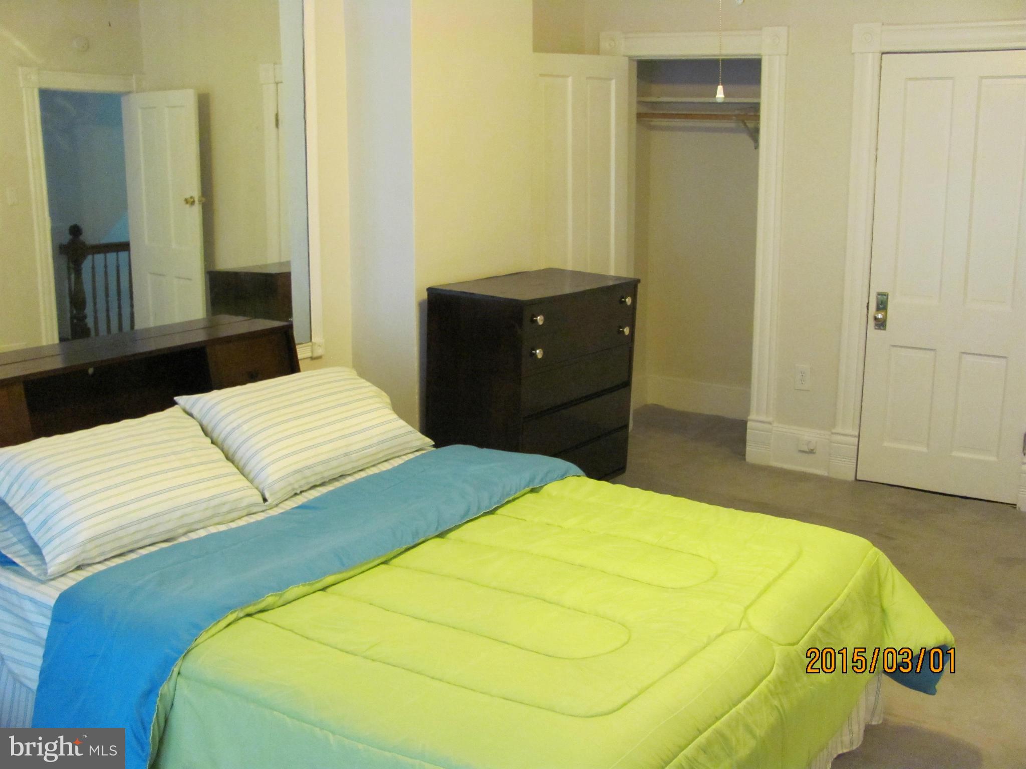 704 Quincy Street Northwest, Unit 202 Washington, DC 20011 - Photo 10 of 24 a bedroom with a bed and dresser