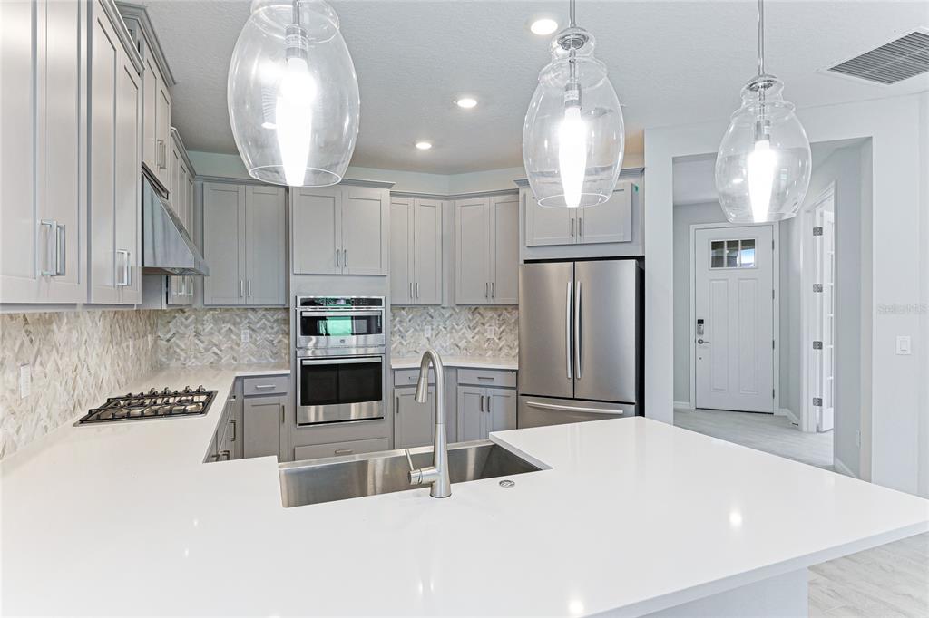 8440 Skye Rnch Boulevard Sarasota, FL 34241 - Photo 11 of 86 a kitchen with stainless steel appliances a refrigerator sink and cabinets