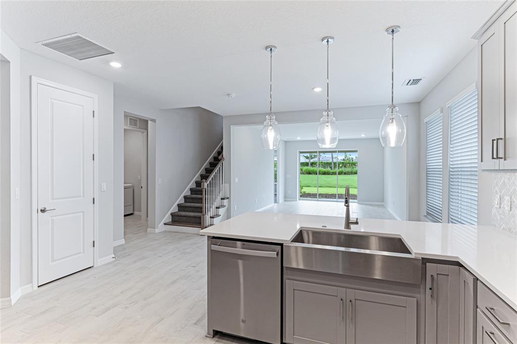 8440 Skye Rnch Boulevard Sarasota, FL 34241 - Photo 12 of 86 a kitchen with kitchen island a sink appliances and a window
