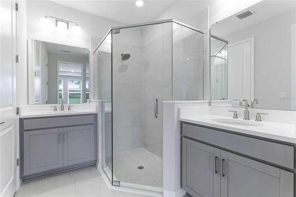 8440 Skye Rnch Boulevard Sarasota, FL 34241 - Photo 21 of 86 a bathroom with a shower sink and mirror