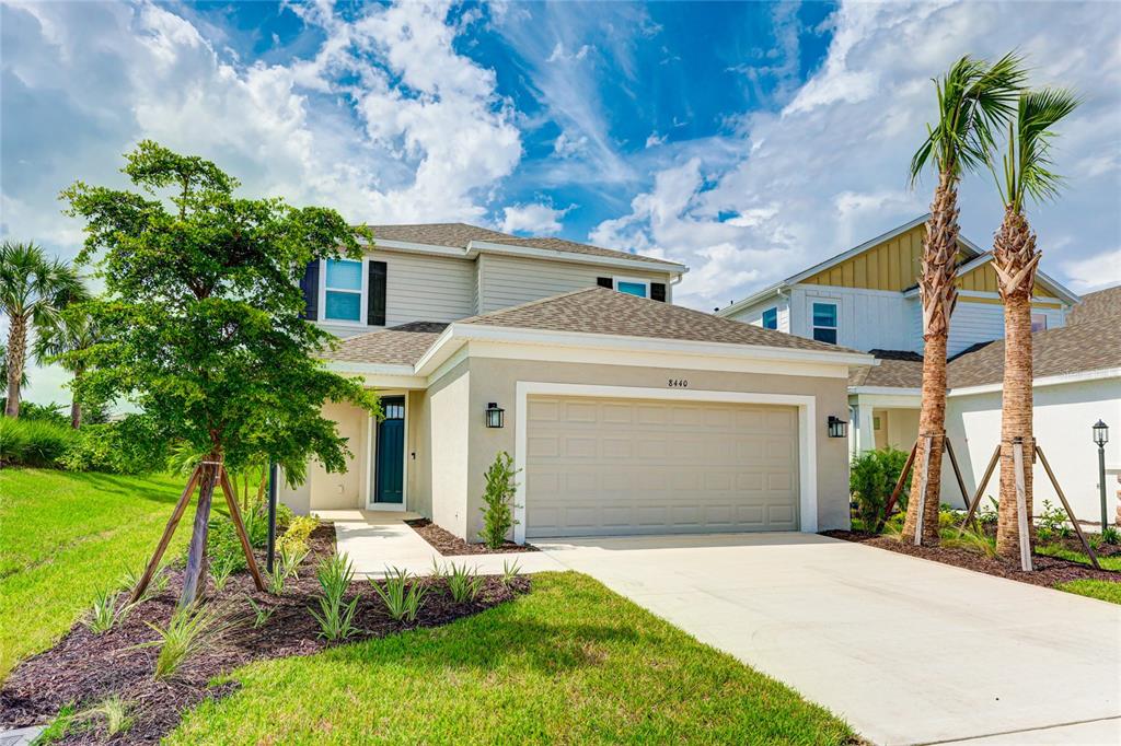 8440 Skye Rnch Boulevard Sarasota, FL 34241 - Photo 3 of 86 a front view of a house with garden