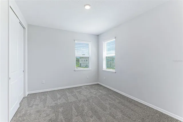 a street sign with potted plants and wooden fence