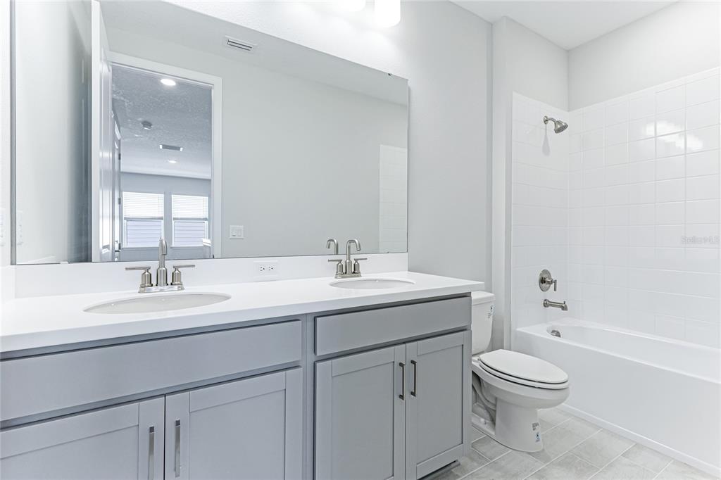 8440 Skye Rnch Boulevard Sarasota, FL 34241 - Photo 36 of 86 a bathroom with a toilet a sink a mirror a bathtub and vanity