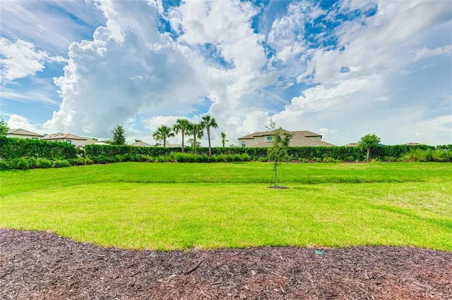 a view of a house with backyard sitting area and garden
