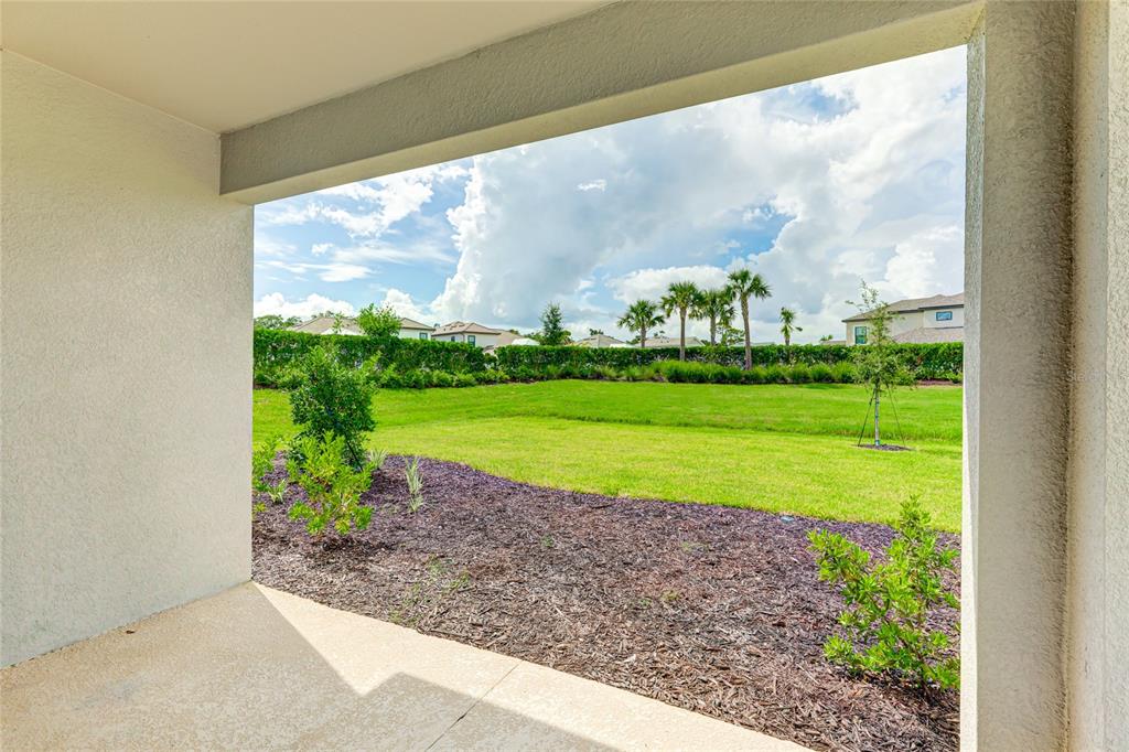 8440 Skye Rnch Boulevard Sarasota, FL 34241 - Photo 47 of 86 a view of a big room with a big yard and potted plants