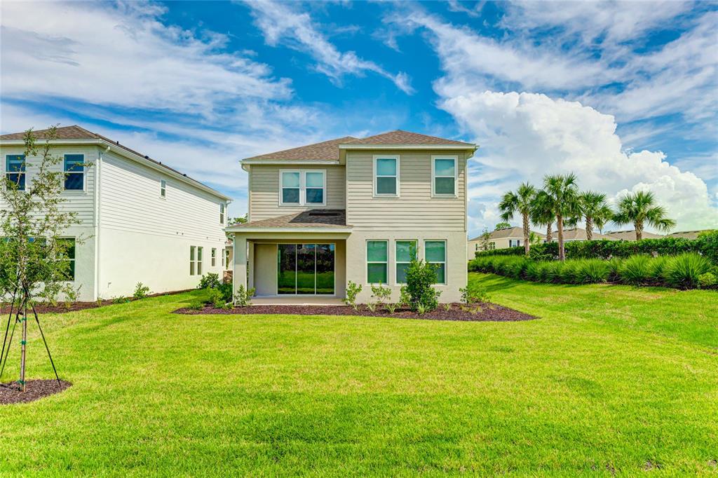 8440 Skye Rnch Boulevard Sarasota, FL 34241 - Photo 50 of 86 a front view of a house with a yard