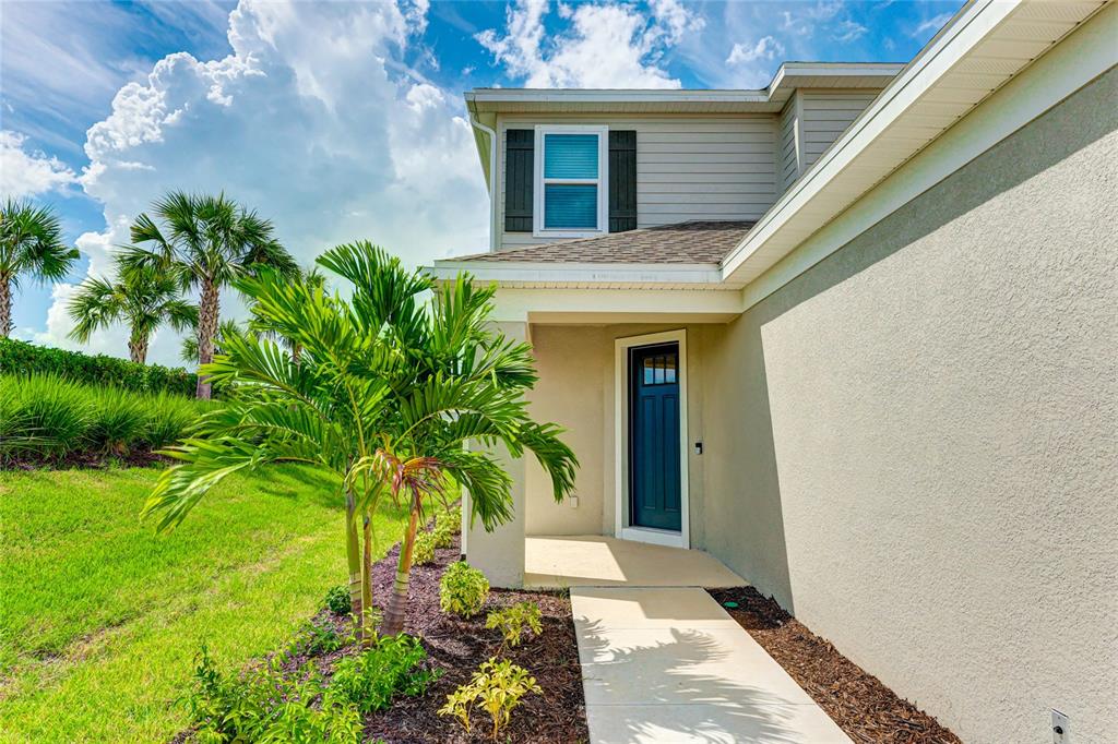 8440 Skye Rnch Boulevard Sarasota, FL 34241 - Photo 5 of 86 a front view of a house with a yard
