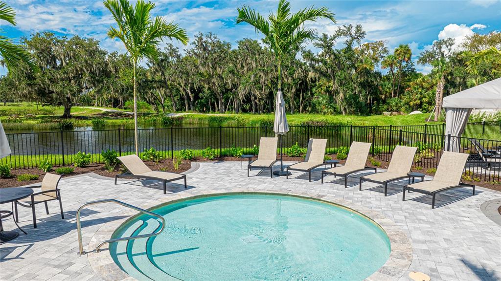 8440 Skye Rnch Boulevard Sarasota, FL 34241 - Photo 61 of 86 a view of a lake with a table and chairs