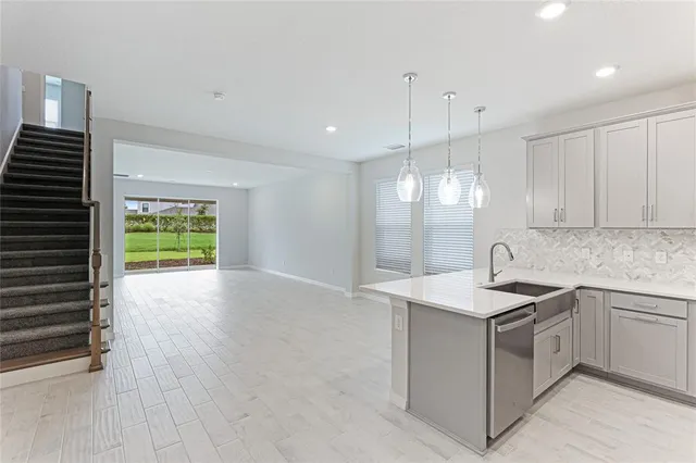 a kitchen with a sink stainless steel appliances and cabinets
