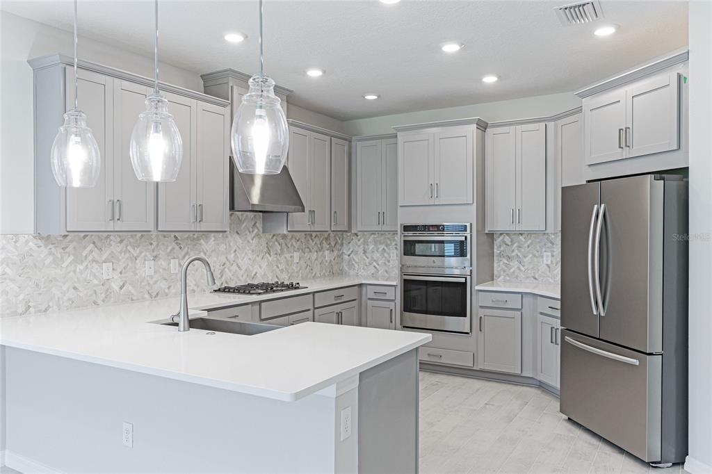 8440 Skye Rnch Boulevard Sarasota, FL 34241 - Photo 10 of 86 a kitchen with a sink stainless steel appliances and cabinets