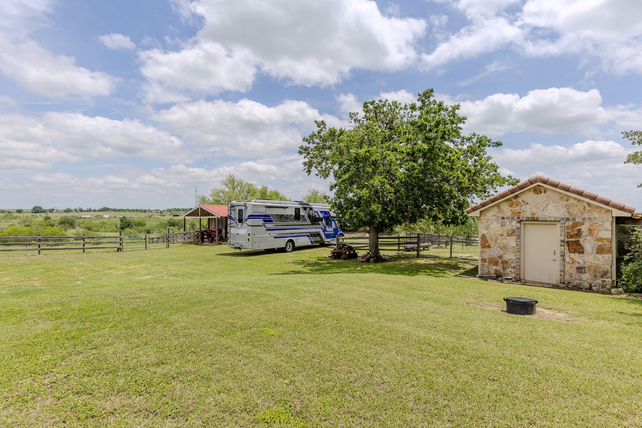 17308 St Therese Road Manor, TX 78653 - Photo 33 of 40 a front view of a house with a garden and lake view