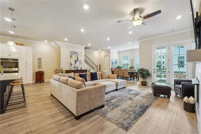 a living room with furniture floor to ceiling window and a fireplace