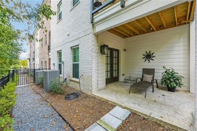 front view of a brick house with a yard