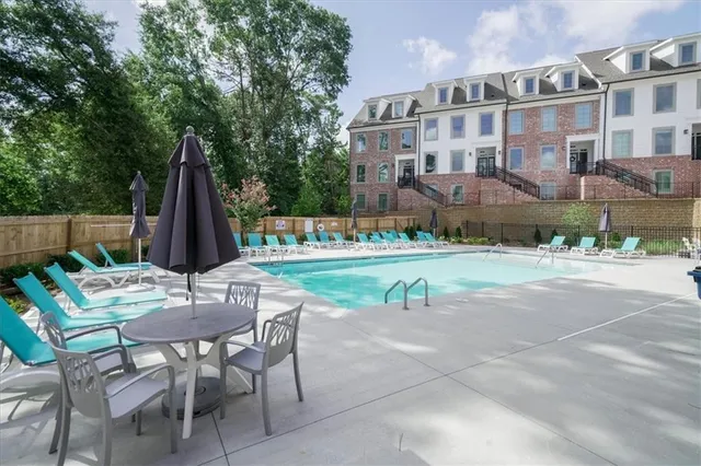 an aerial view of a house with outdoor seating