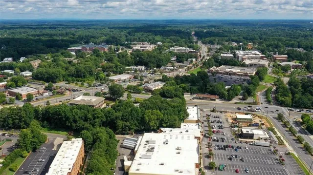 a front view of a house with a garden and plants