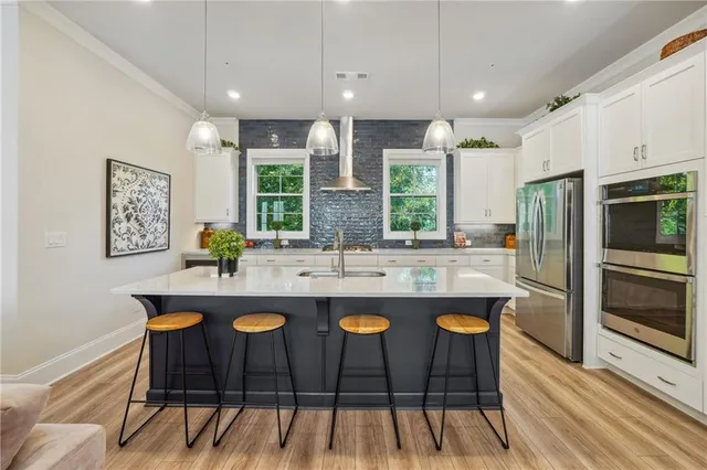 a kitchen with a refrigerator sink and stove