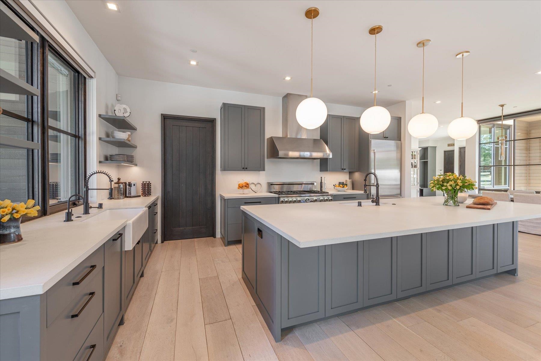 7750 Lahontan Drive Truckee, CA 96161 - Photo 11 of 21 a kitchen with kitchen island granite countertop a sink cabinets and a chandelier