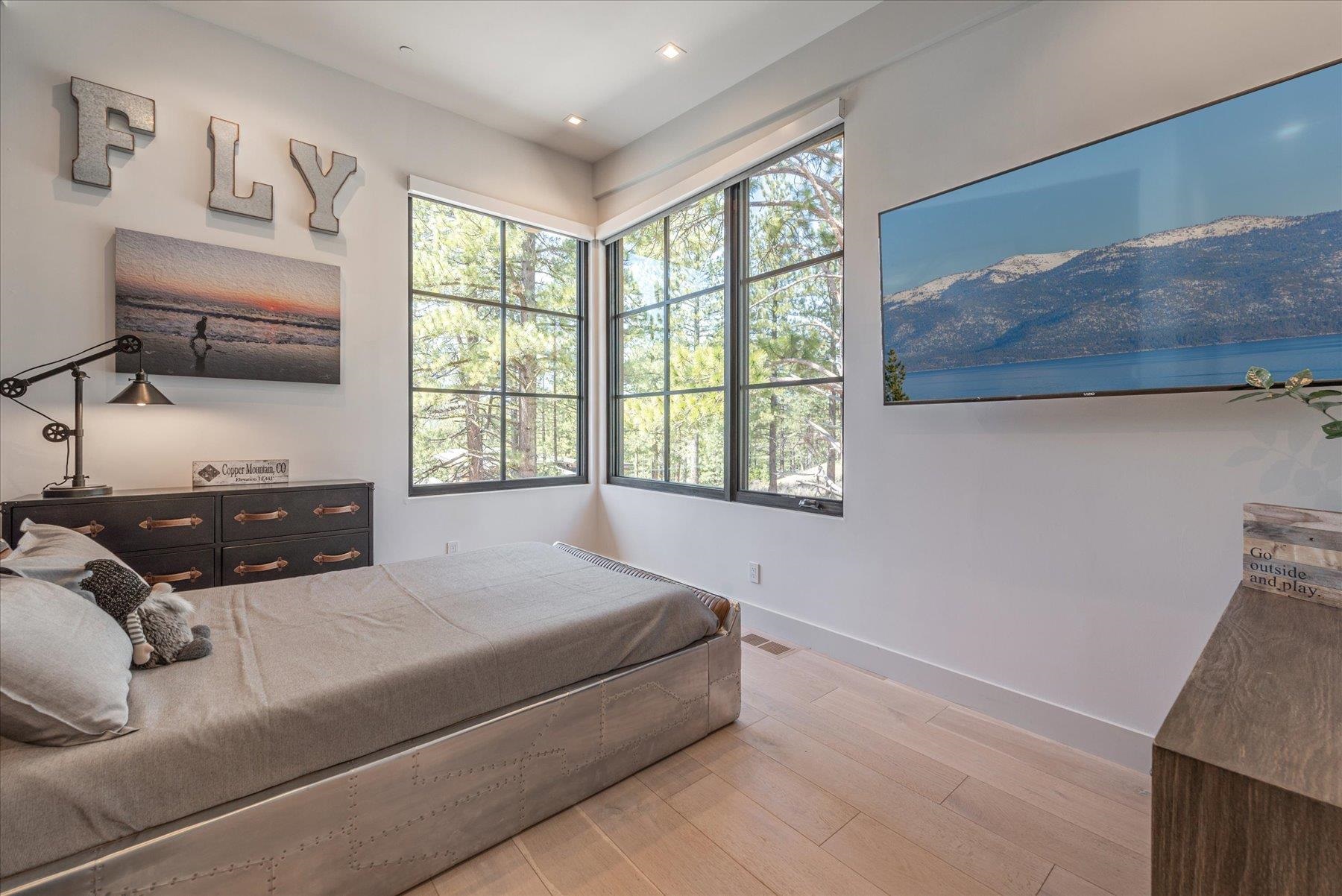 7750 Lahontan Drive Truckee, CA 96161 - Photo 18 of 21 a spacious bedroom with a bed and a window