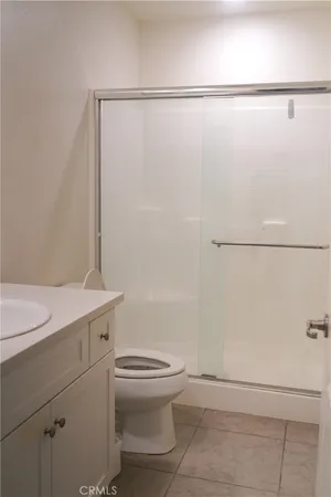 a bathroom with a granite countertop sink mirror and toilet