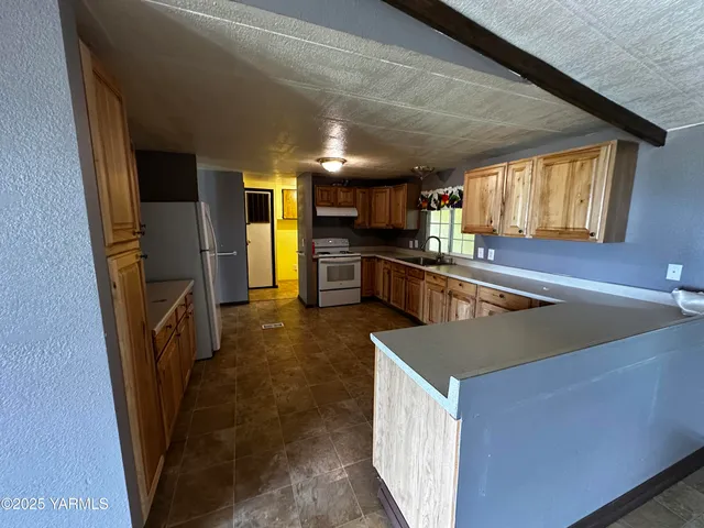 a kitchen with lots of counter top space and stainless steel appliances