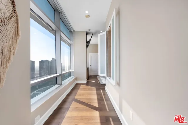 a view of a balcony with wooden floor and door