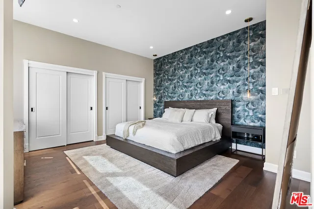 a large bed sitting in a bedroom next to a cabinet