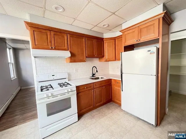 a kitchen with stainless steel appliances granite countertop a refrigerator stove a sink dishwasher and microwave with cabinets