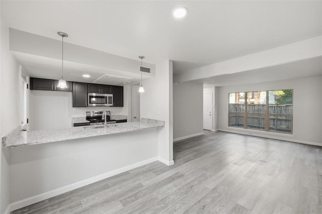 2702 Douglas Avenue, Unit 121 Dallas, TX 75219 - Photo 13 of 34 a view of kitchen with wooden floor and electronic appliances