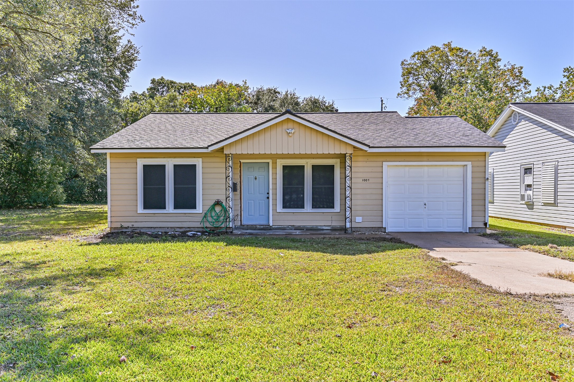 a view of a house with a swimming pool and a yard