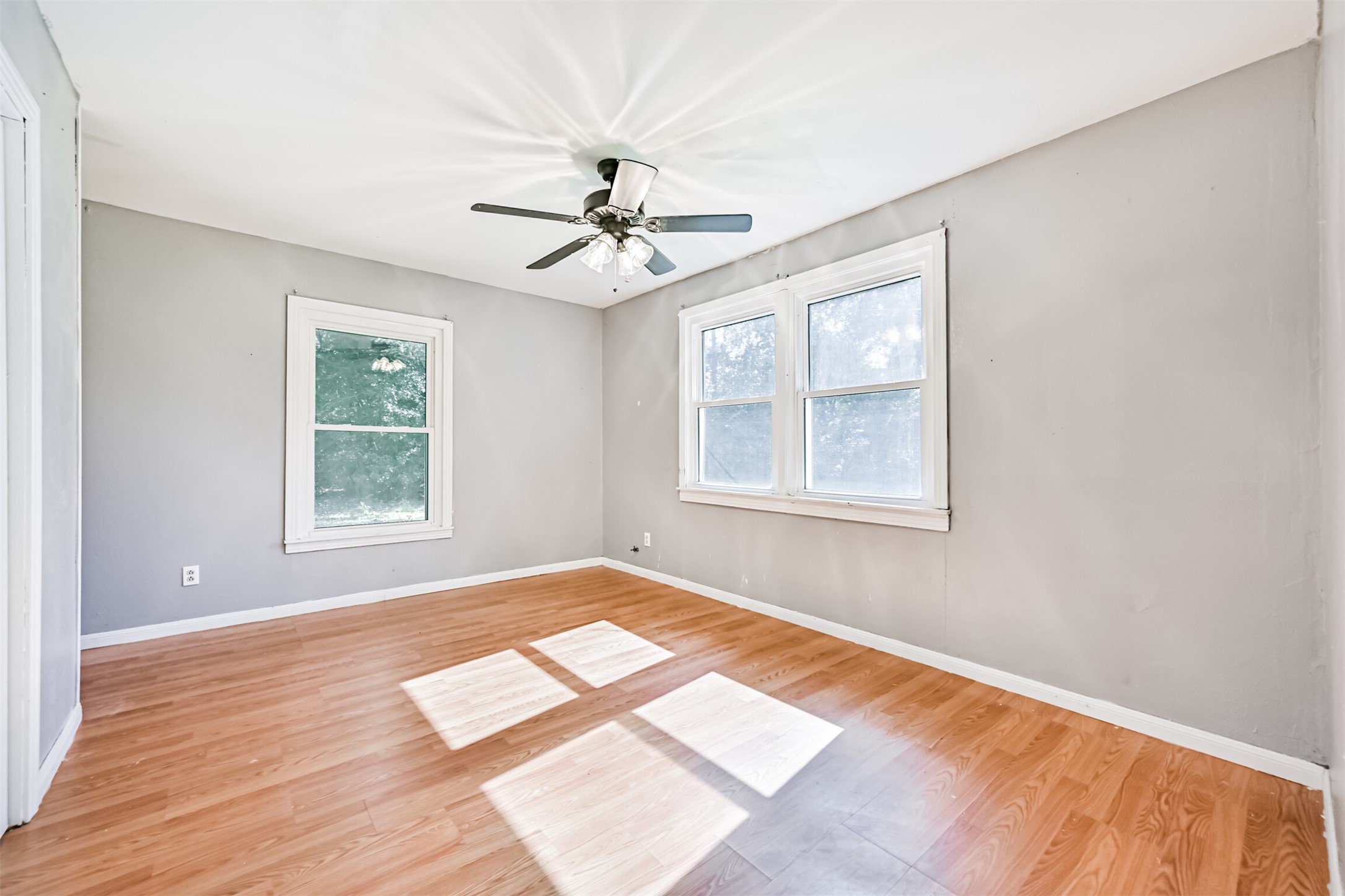 1007 Plum Street La Marque, TX 77568 - Photo 13 of 16 a view of an empty room with a window and wooden floor