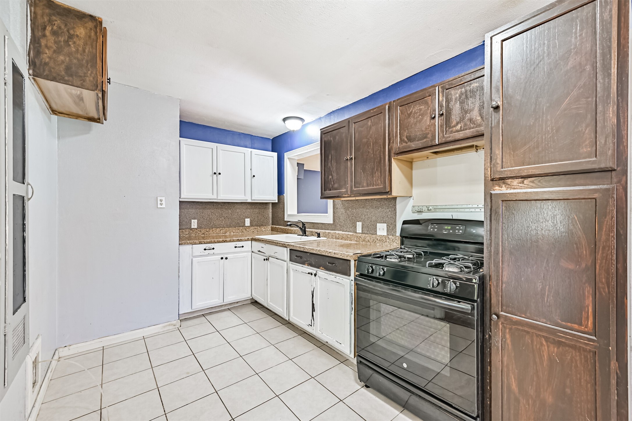 1007 Plum Street La Marque, TX 77568 - Photo 5 of 16 a kitchen with a refrigerator sink and cabinets