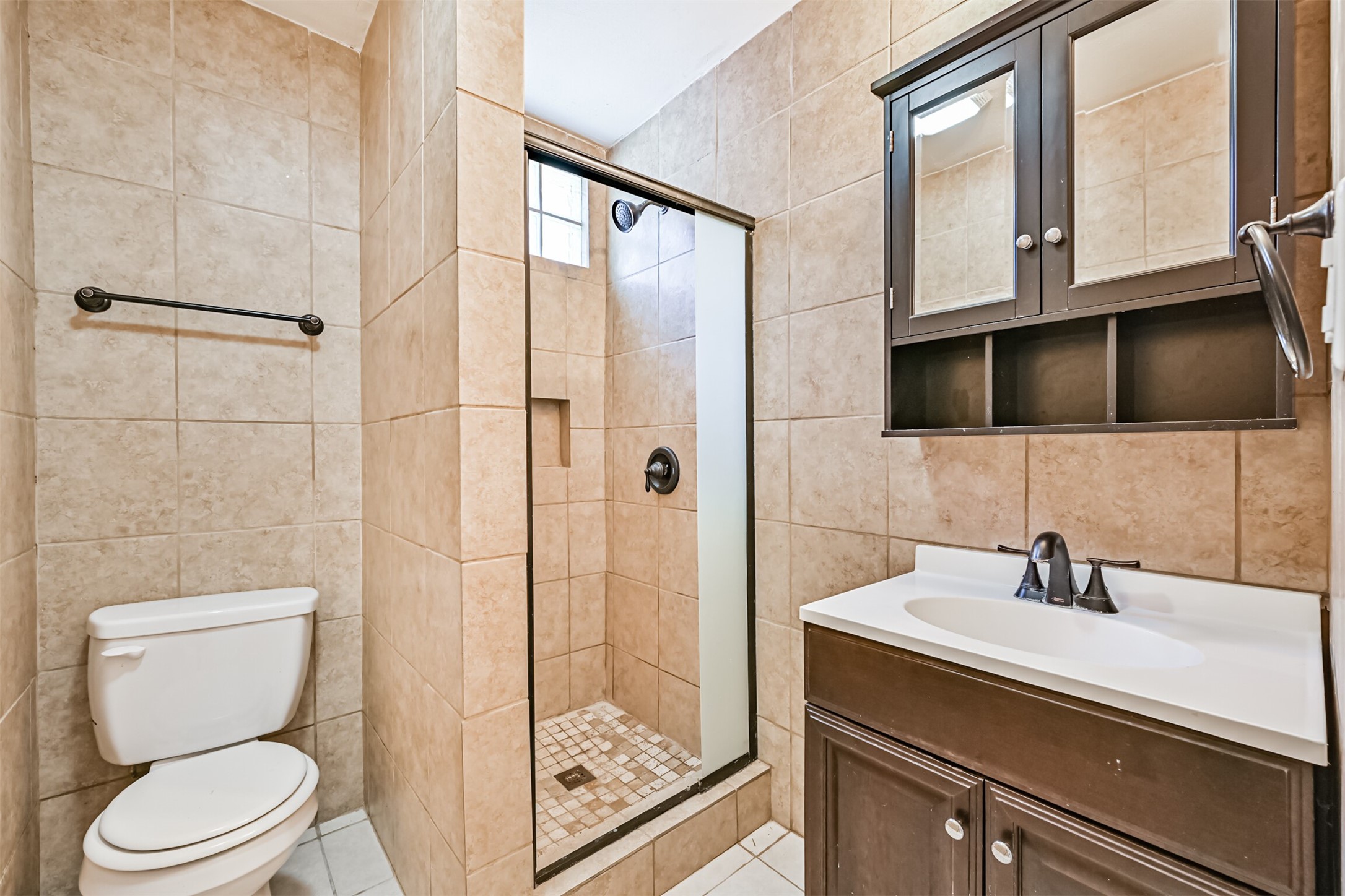 1007 Plum Street La Marque, TX 77568 - Photo 6 of 16 a bathroom with a sink a toilet and shower