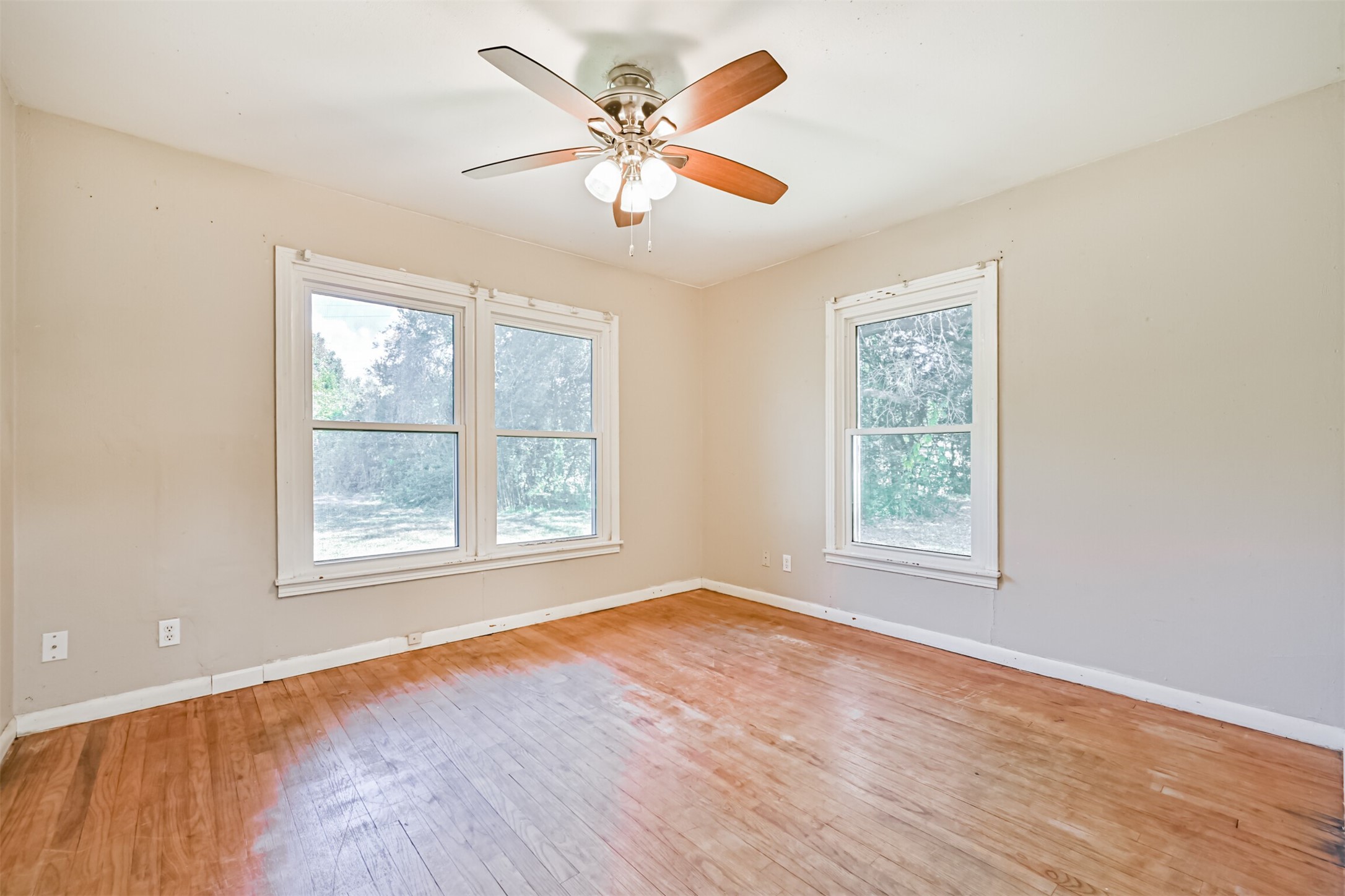 1007 Plum Street La Marque, TX 77568 - Photo 7 of 16 an empty room with wooden floor and windows
