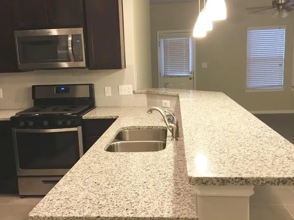 a kitchen with a sink stove and microwave
