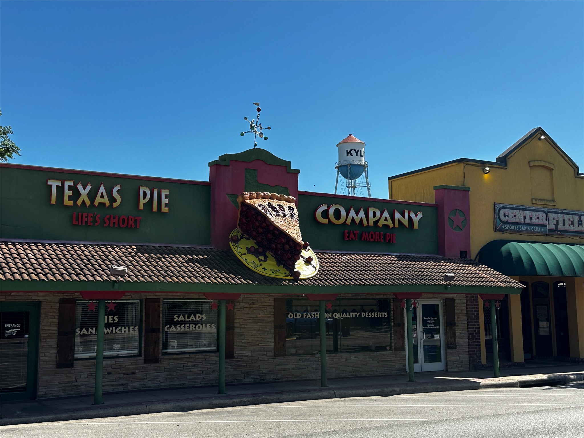 Tbd Scott Street Kyle, TX 78640 - Photo 26 of 30 a front view of multi story building with retail shop and sign board