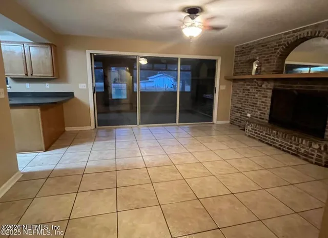 a view of entryway with a fireplace and window
