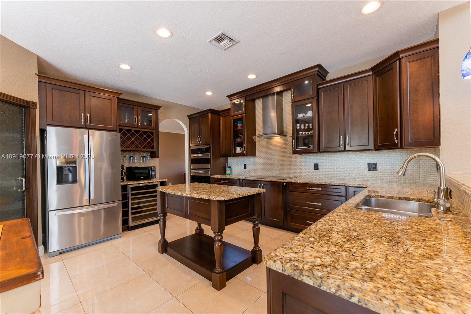 12358 St Simon Drive Boca Raton, FL 33428 - Photo 12 of 89 a kitchen with stainless steel appliances granite countertop a refrigerator sink and stove