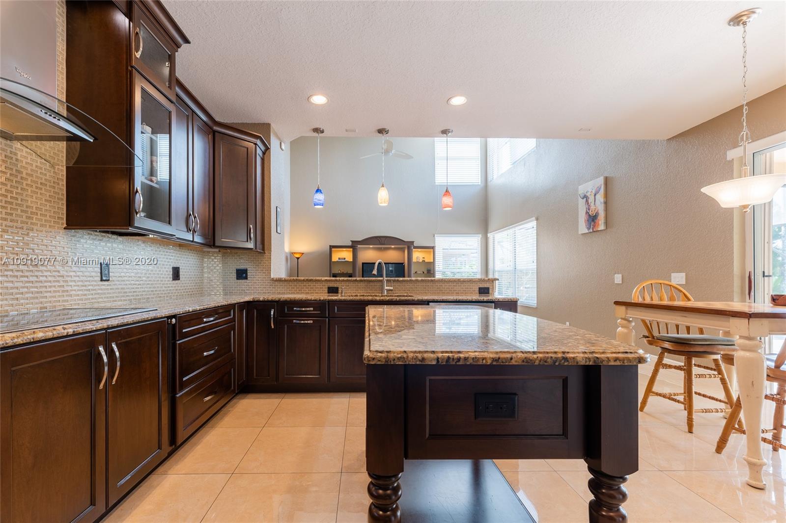 12358 St Simon Drive Boca Raton, FL 33428 - Photo 17 of 89 a kitchen with stainless steel appliances granite countertop a stove a sink and a microwave