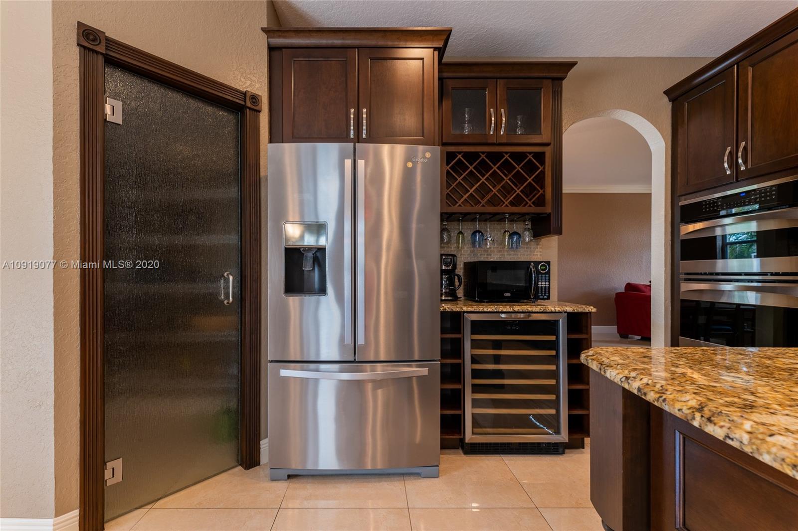 12358 St Simon Drive Boca Raton, FL 33428 - Photo 18 of 89 a kitchen with stainless steel appliances granite countertop a refrigerator and a stove top oven