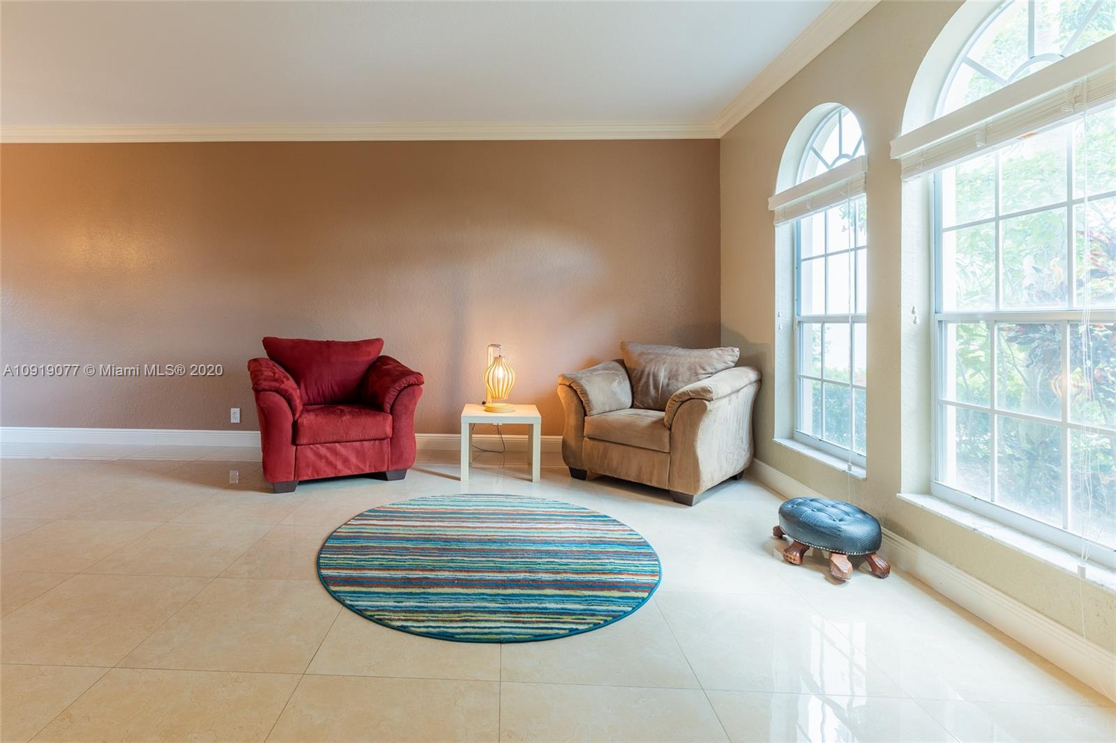12358 St Simon Drive Boca Raton, FL 33428 - Photo 22 of 89 a living room with furniture and a floor to ceiling window