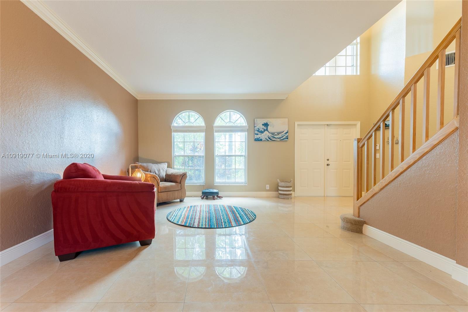 12358 St Simon Drive Boca Raton, FL 33428 - Photo 23 of 89 a living room with furniture a fireplace and a large window