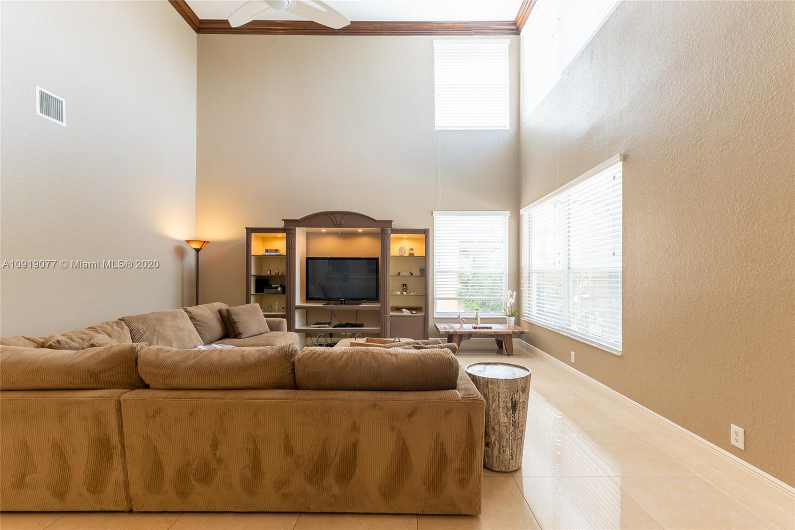 12358 St Simon Drive Boca Raton, FL 33428 - Photo 24 of 89 a living room with furniture and a large window