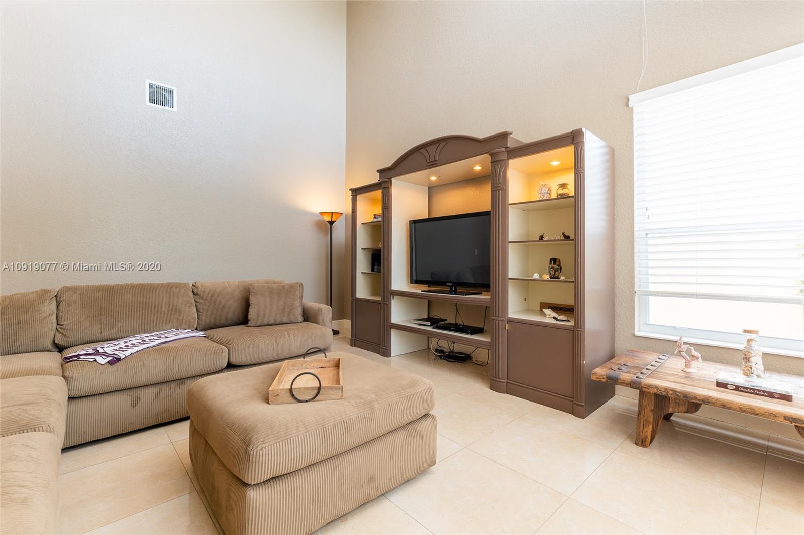 12358 St Simon Drive Boca Raton, FL 33428 - Photo 26 of 89 a living room with furniture and a flat screen tv