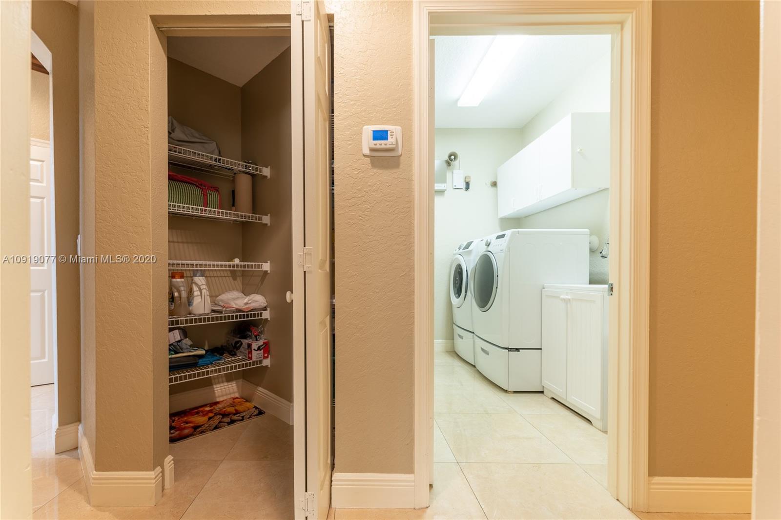 12358 St Simon Drive Boca Raton, FL 33428 - Photo 30 of 89 a bathroom with a glass shower door